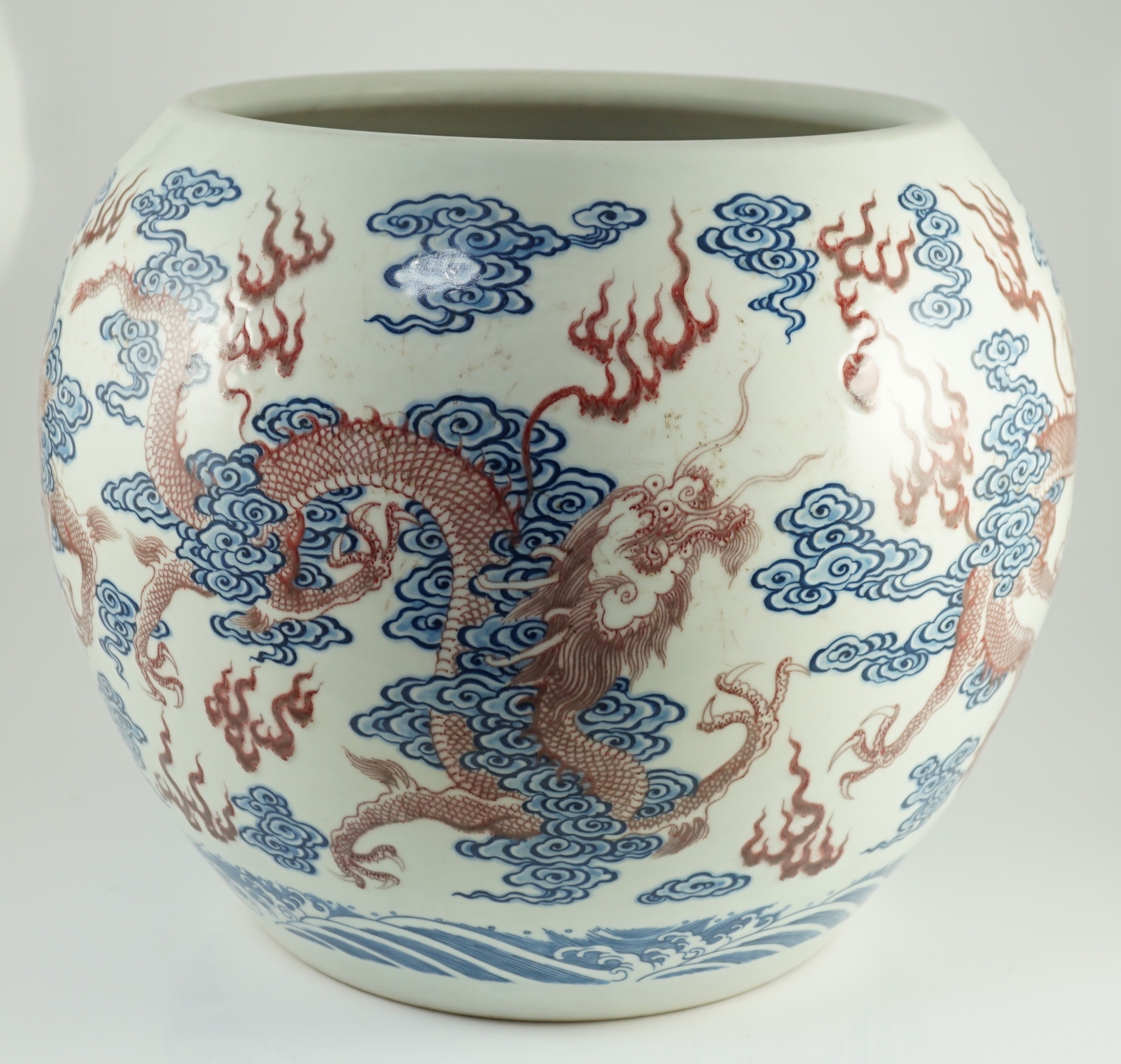 A large Chinese underglaze blue and copper red 'dragon' scroll vessel, 42.5cm diameter, 34.5cm high